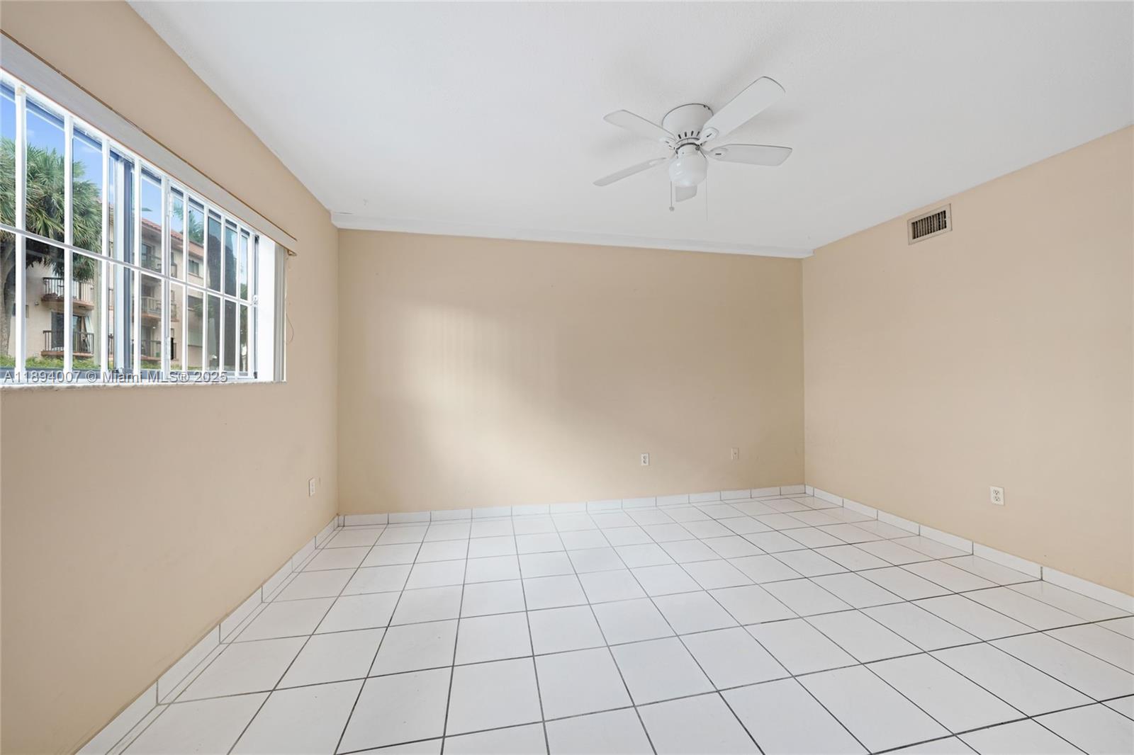 5490 West 21st Court, Unit 112 Hialeah, FL 33016 - Photo 11 of 43 a view of an empty room with a window