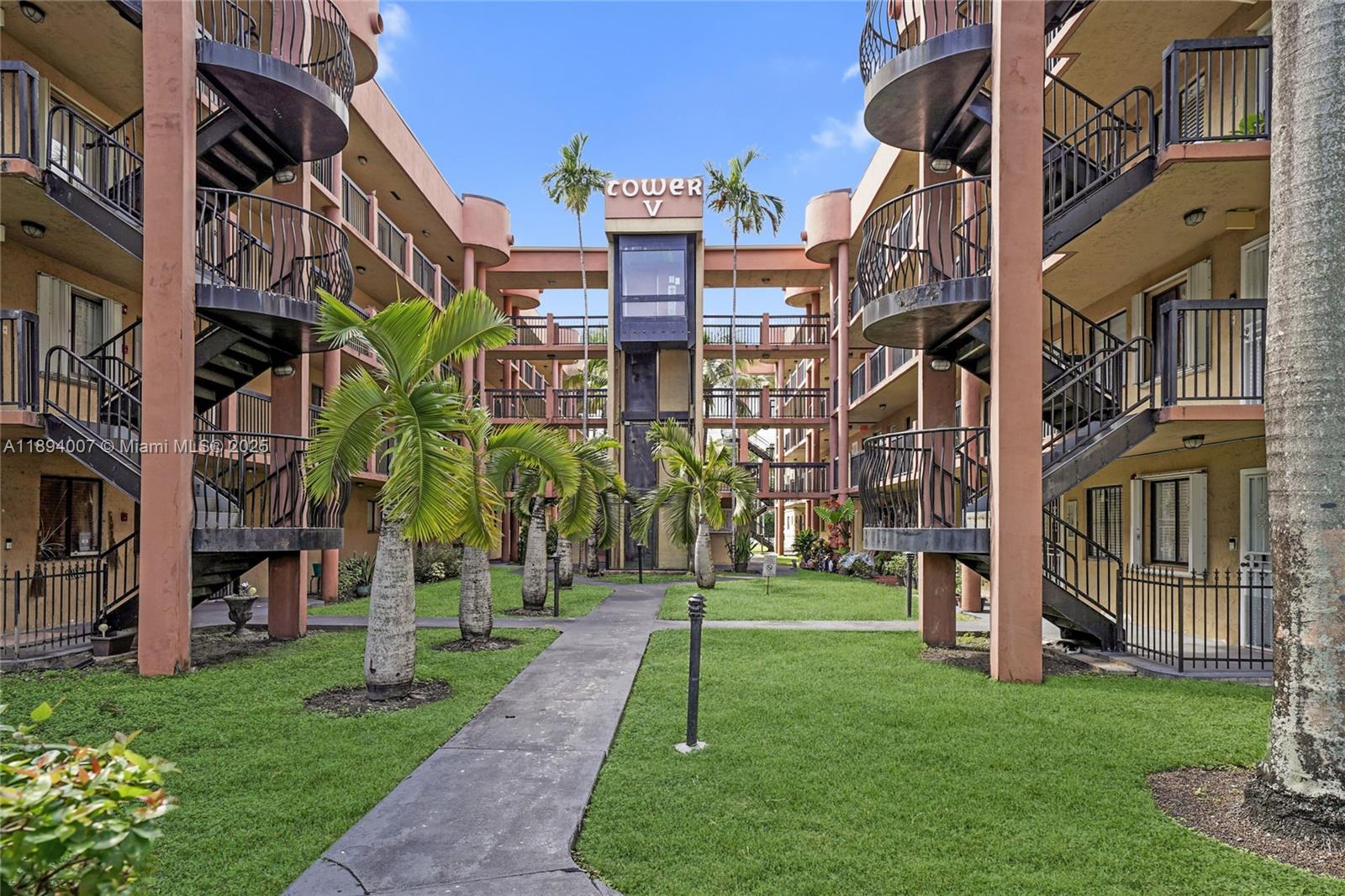 5490 West 21st Court, Unit 112 Hialeah, FL 33016 - Photo 12 of 43 a view of a building with a yard