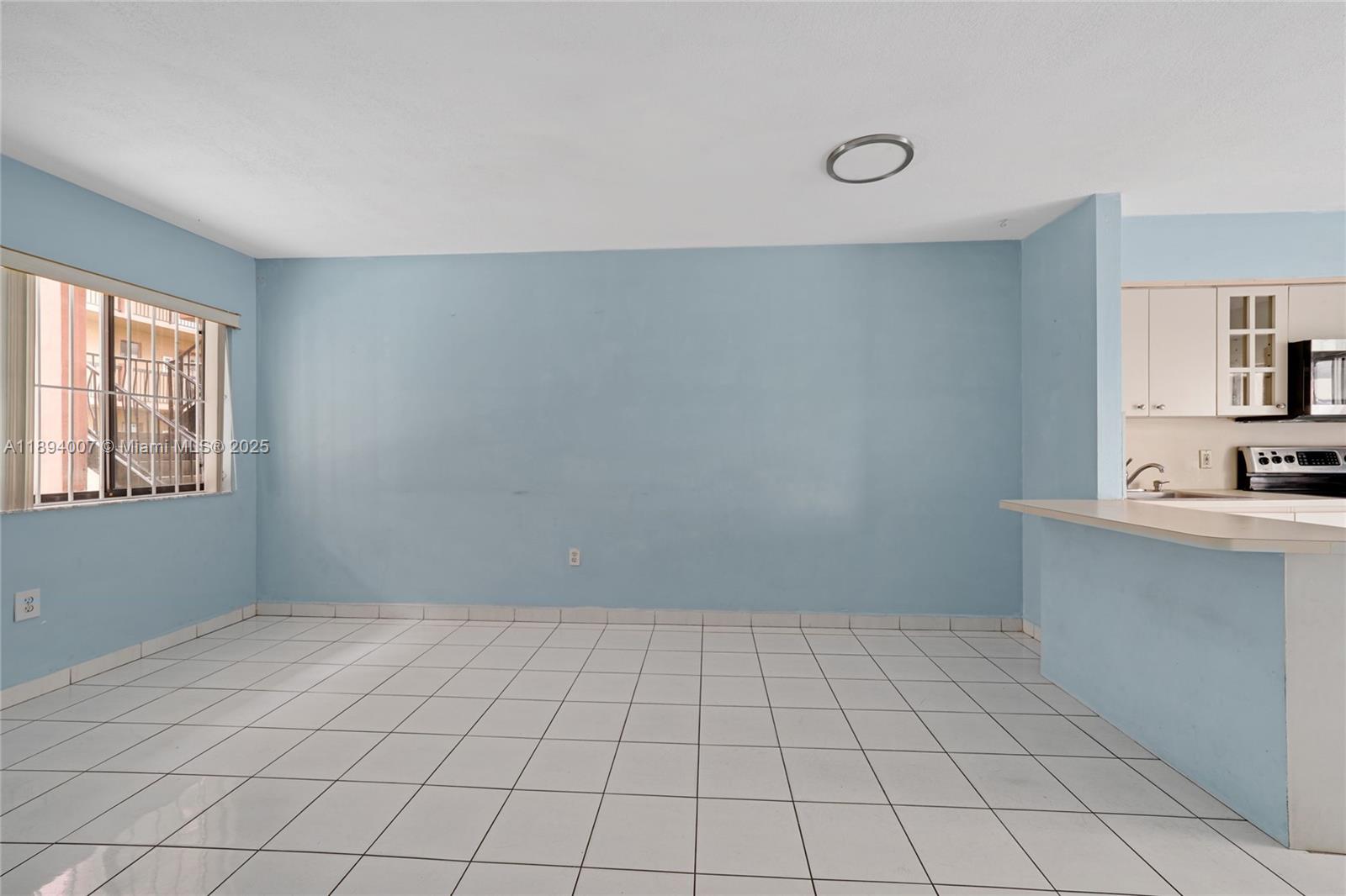 5490 West 21st Court, Unit 112 Hialeah, FL 33016 - Photo 18 of 43 a view of an empty room with window and cabinet