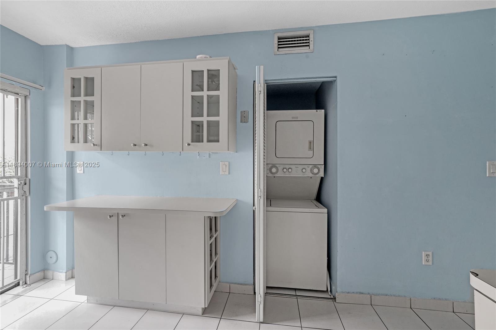 5490 West 21st Court, Unit 112 Hialeah, FL 33016 - Photo 23 of 43 a hallway with cabinets and window