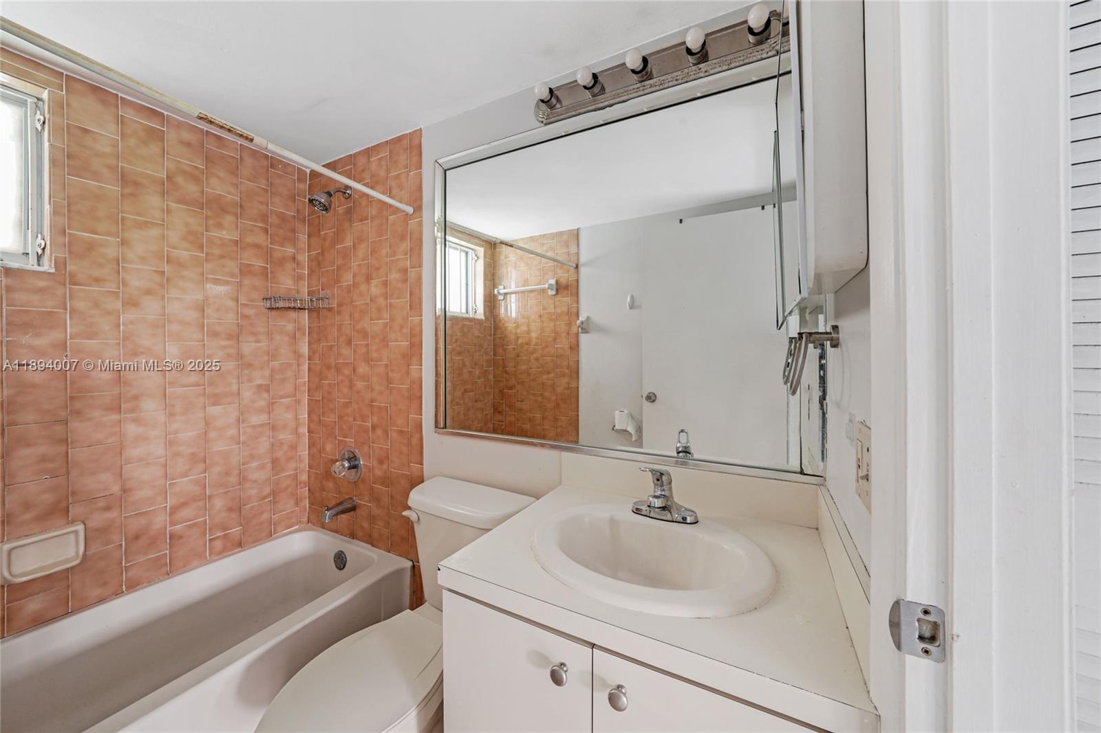 5490 West 21st Court, Unit 112 Hialeah, FL 33016 - Photo 39 of 43 a bathroom with a sink and a mirror