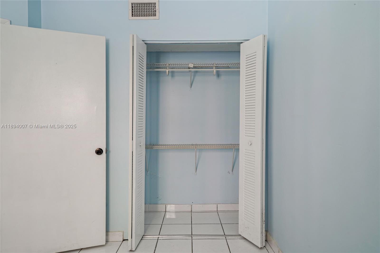 5490 West 21st Court, Unit 112 Hialeah, FL 33016 - Photo 4 of 43 a view of an empty walk in closet