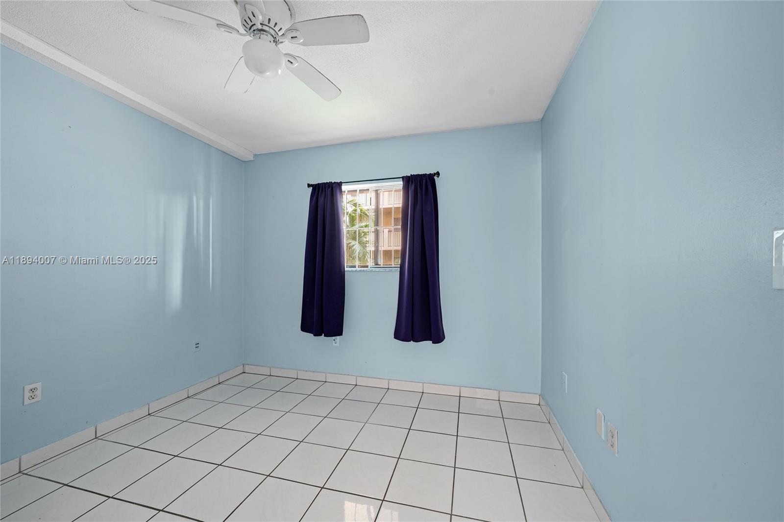 5490 West 21st Court, Unit 112 Hialeah, FL 33016 - Photo 42 of 43 a view of an empty room with window and chandelier fan