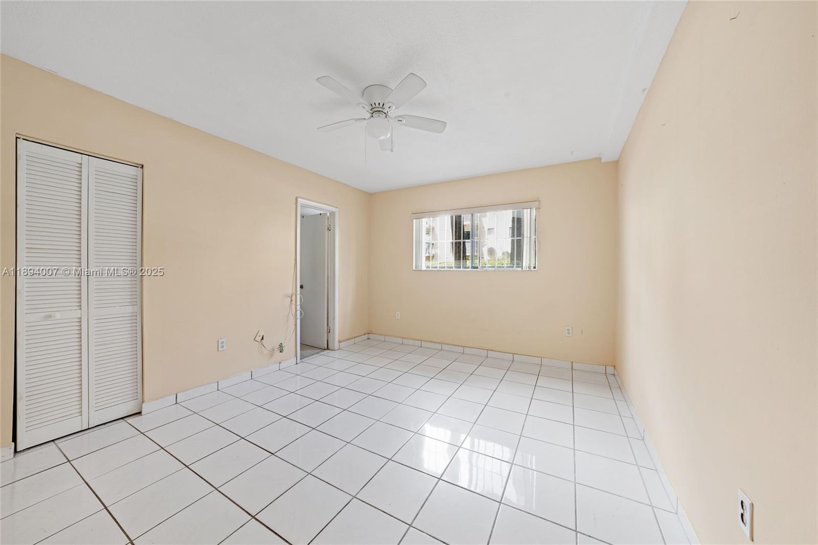 5490 West 21st Court, Unit 112 Hialeah, FL 33016 - Photo 6 of 43 a view of an empty room with a window