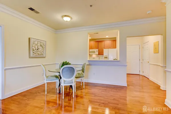 a room with dining table and wooden floor