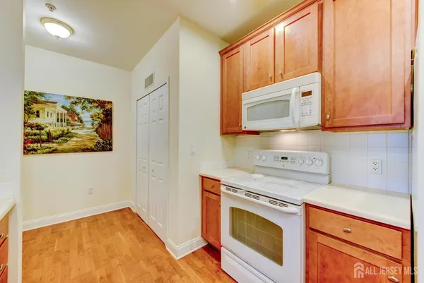 a kitchen with stainless steel appliances granite countertop a stove a microwave and cabinets