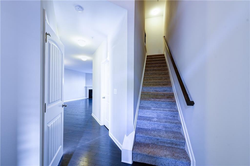 1226 Fischer Trace Cumming, GA 30041 - Photo 2 of 24 a view of a hallway with wooden floor and staircase