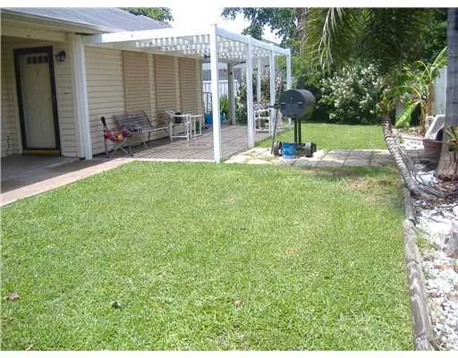 a view of a backyard with sitting area and garden