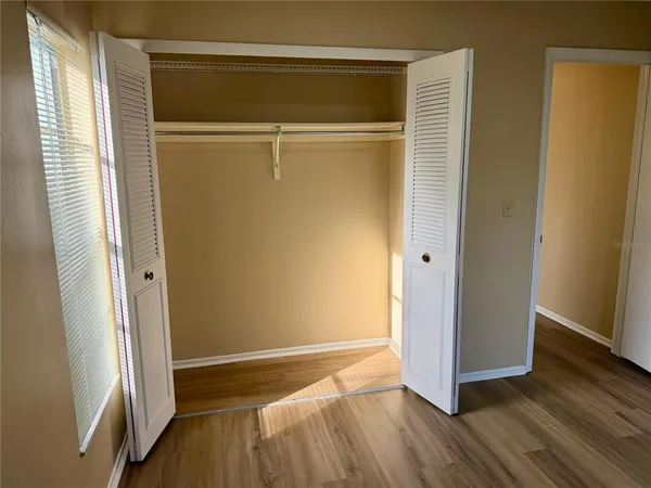 a view of walk in closet with empty room