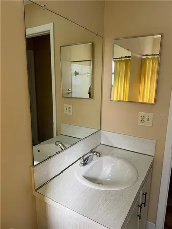a bathroom with a sink and a mirror