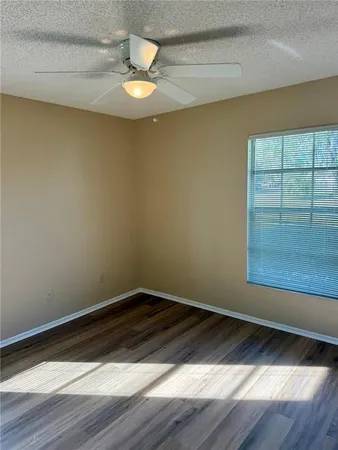 a view of a room with wooden floor and window