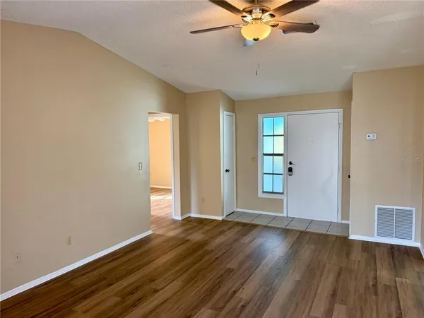 wooden floor in an empty room with a window