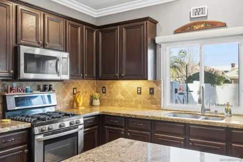 a kitchen with granite countertop a stove and a sink