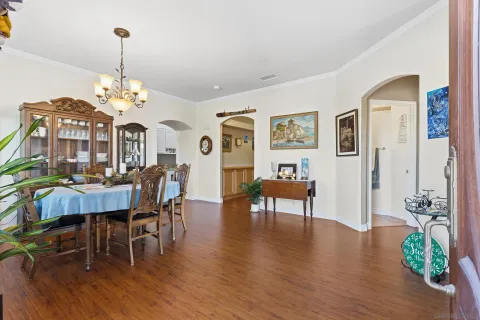 a view of a dining room with furniture wooden floor and chandelier