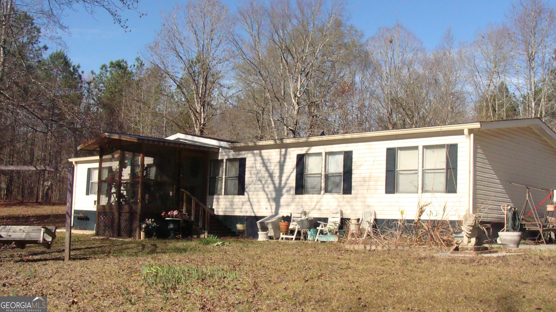a view of a house with backyard porch and sitting area