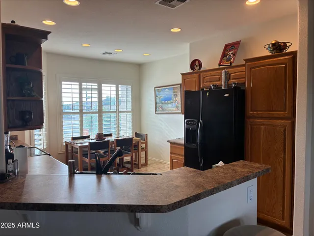 a living room with furniture large window and wooden floor