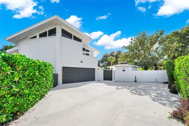 a view of a house with a yard and plants