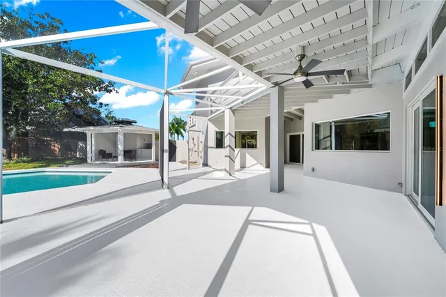 a view of a patio with table and chairs and potted plants