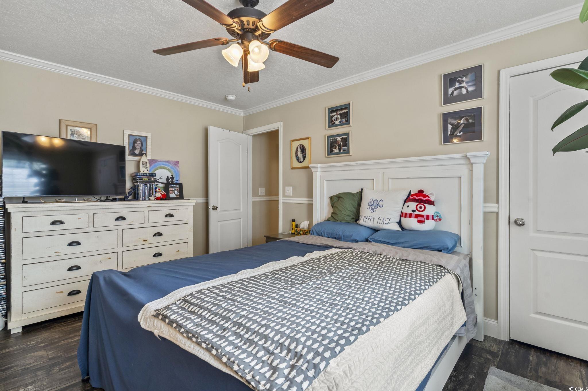 79 Offshore Drive Murrells Inlet, SC 29576 - Photo 12 of 31 Bedroom with ornamental molding, a textured ceiling, dark wood-style floors, and ceiling fan