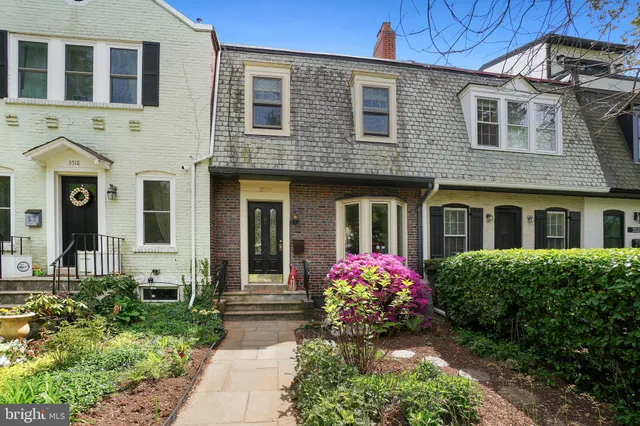 a view of a house with a door and wooden wall