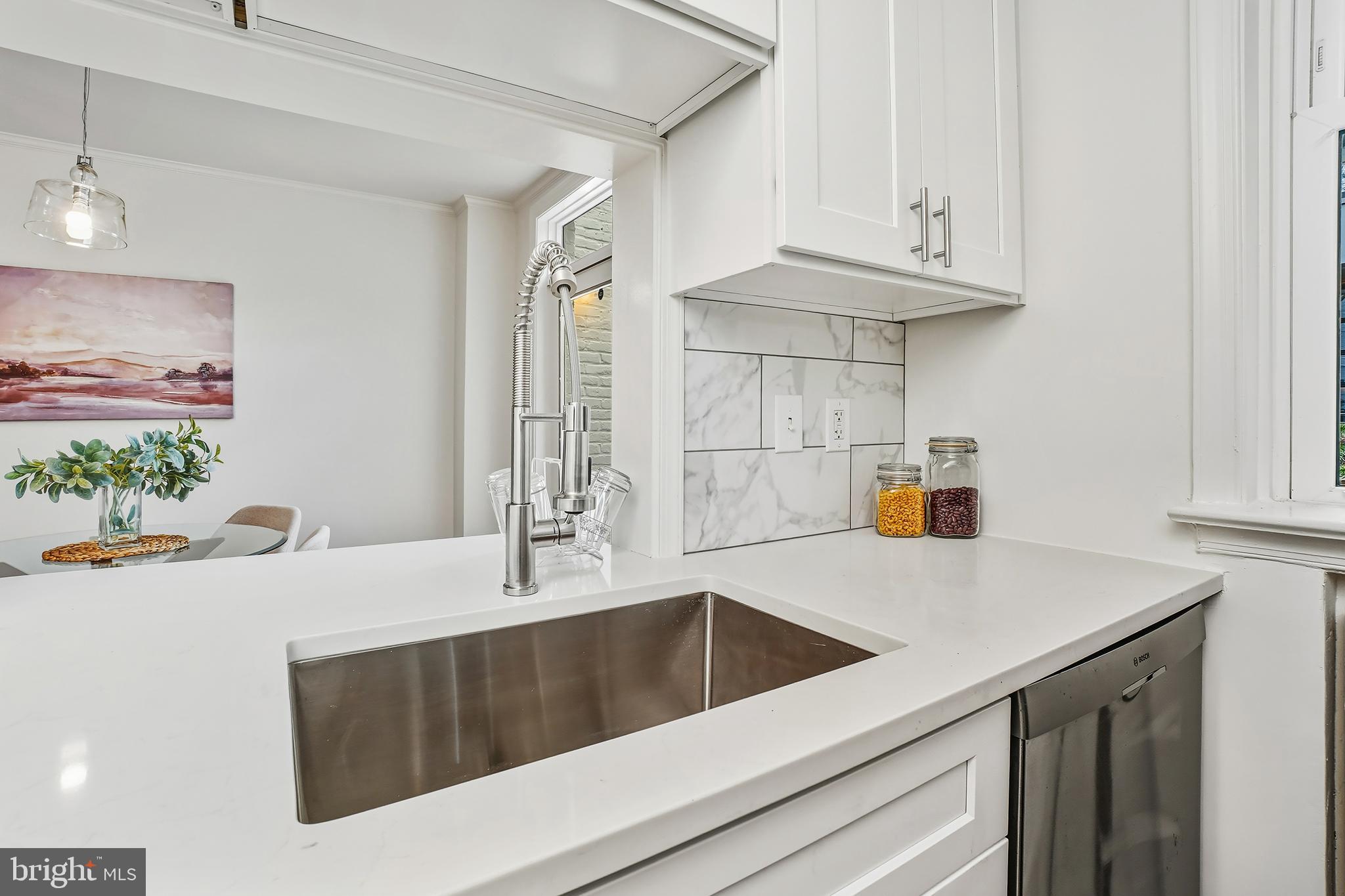 3520 S Street Northwest Washington, DC 20007 - Photo 12 of 44 a kitchen with stainless steel appliances a sink a stove and white cabinets