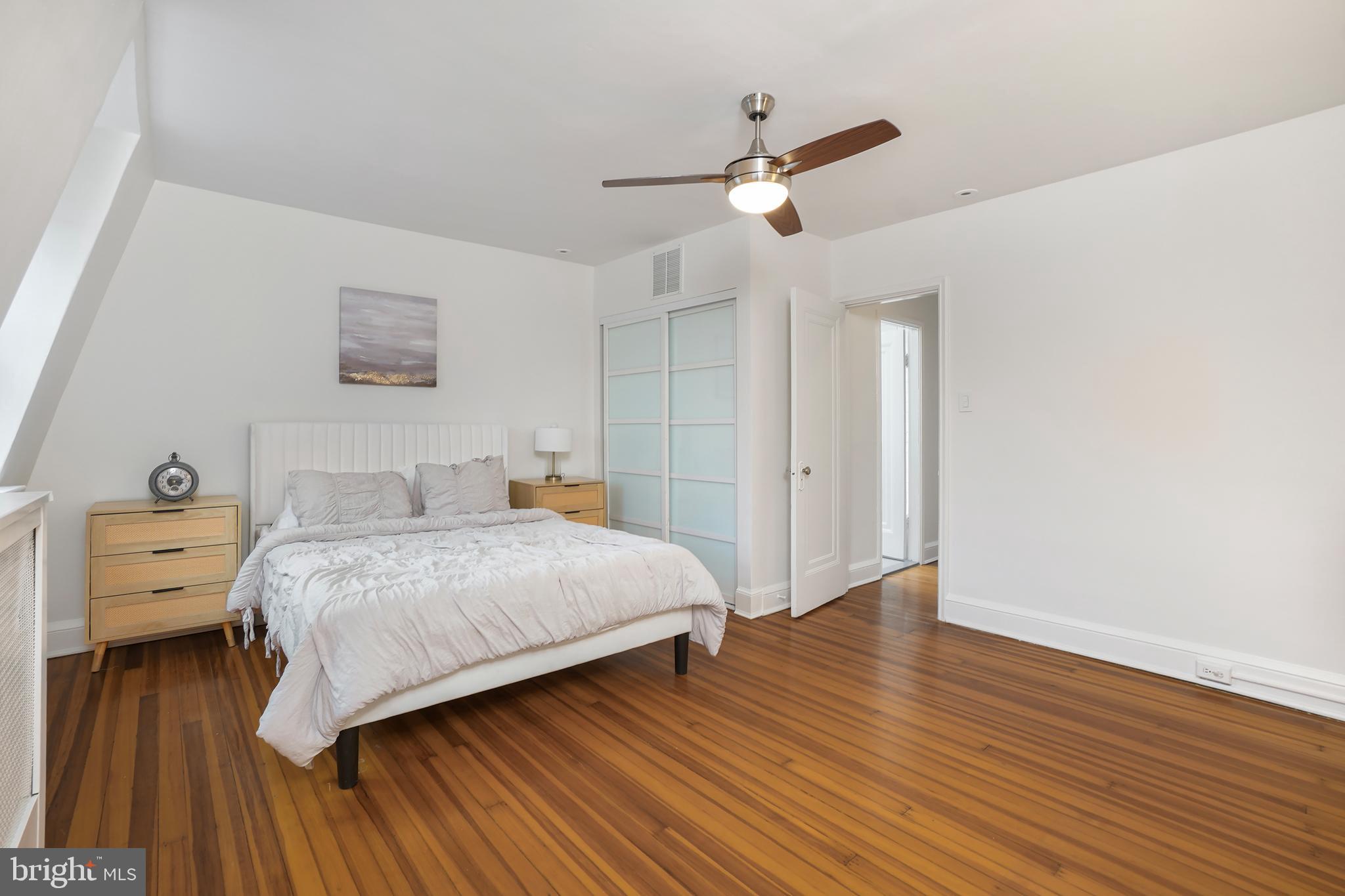 3520 S Street Northwest Washington, DC 20007 - Photo 15 of 44 a spacious bedroom with a bed and wooden floor