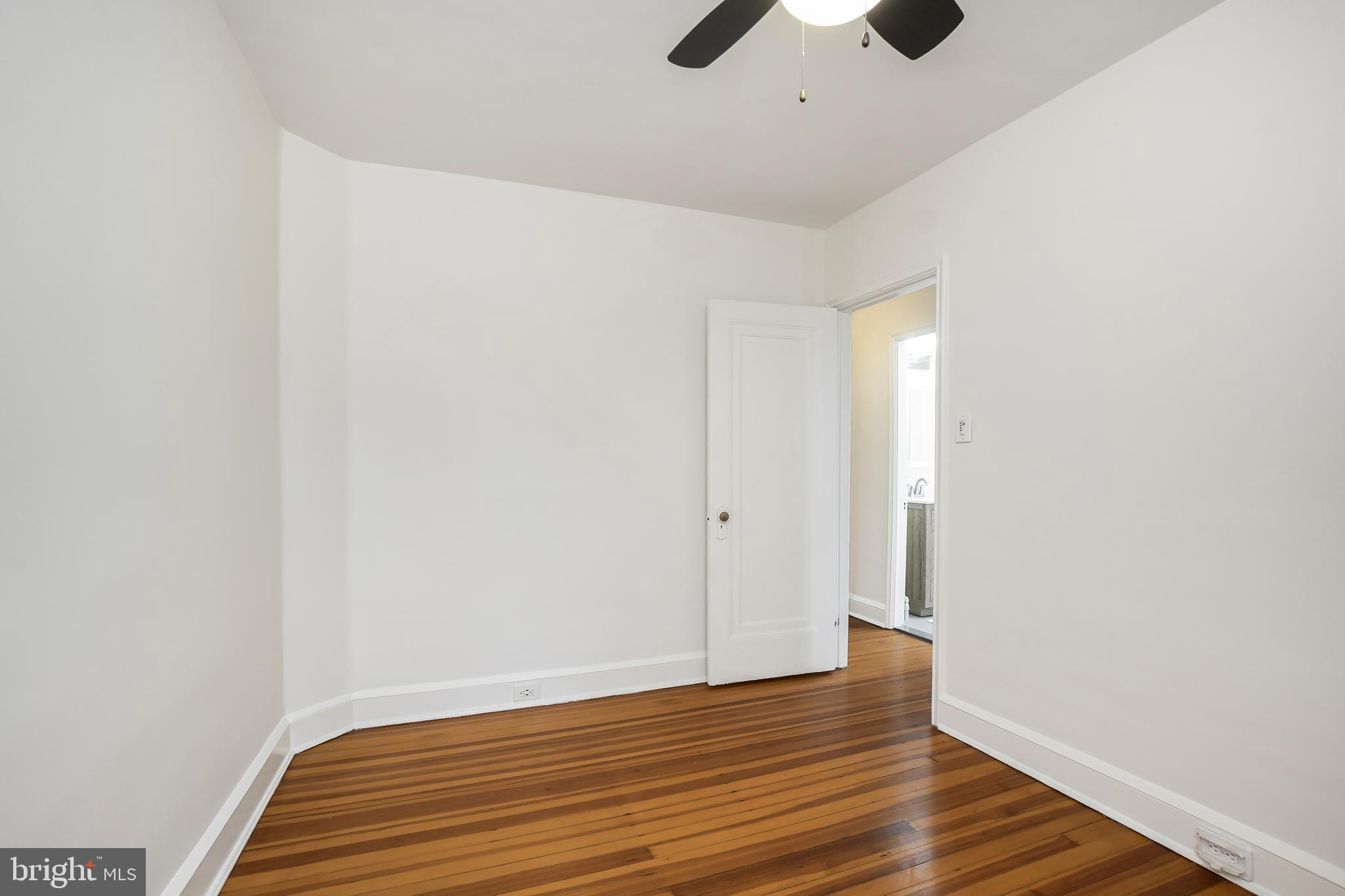 3520 S Street Northwest Washington, DC 20007 - Photo 20 of 44 a view of room with wooden floor and fan