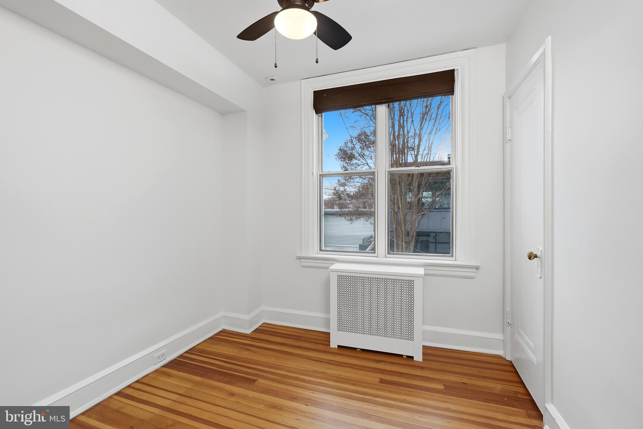3520 S Street Northwest Washington, DC 20007 - Photo 21 of 44 an empty room with wooden floor fan and window
