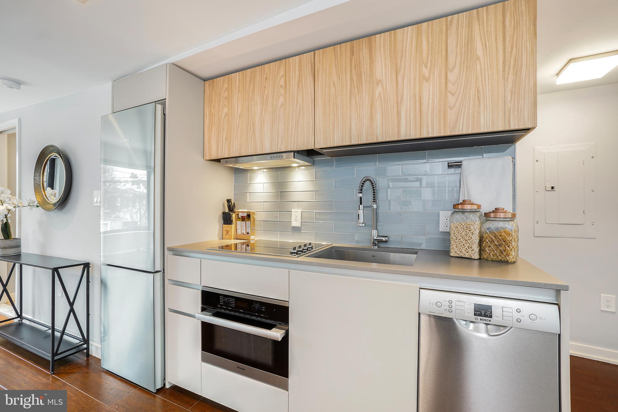 3520 S Street Northwest Washington, DC 20007 - Photo 28 of 44 a kitchen with stainless steel appliances granite countertop a sink and cabinets