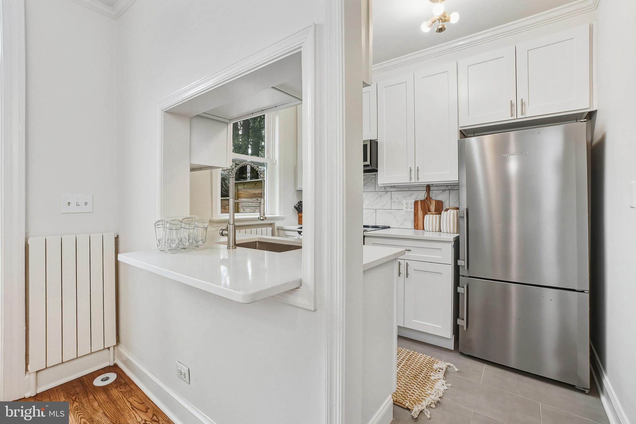 3520 S Street Northwest Washington, DC 20007 - Photo 9 of 44 a kitchen with stainless steel appliances a refrigerator sink and cabinets