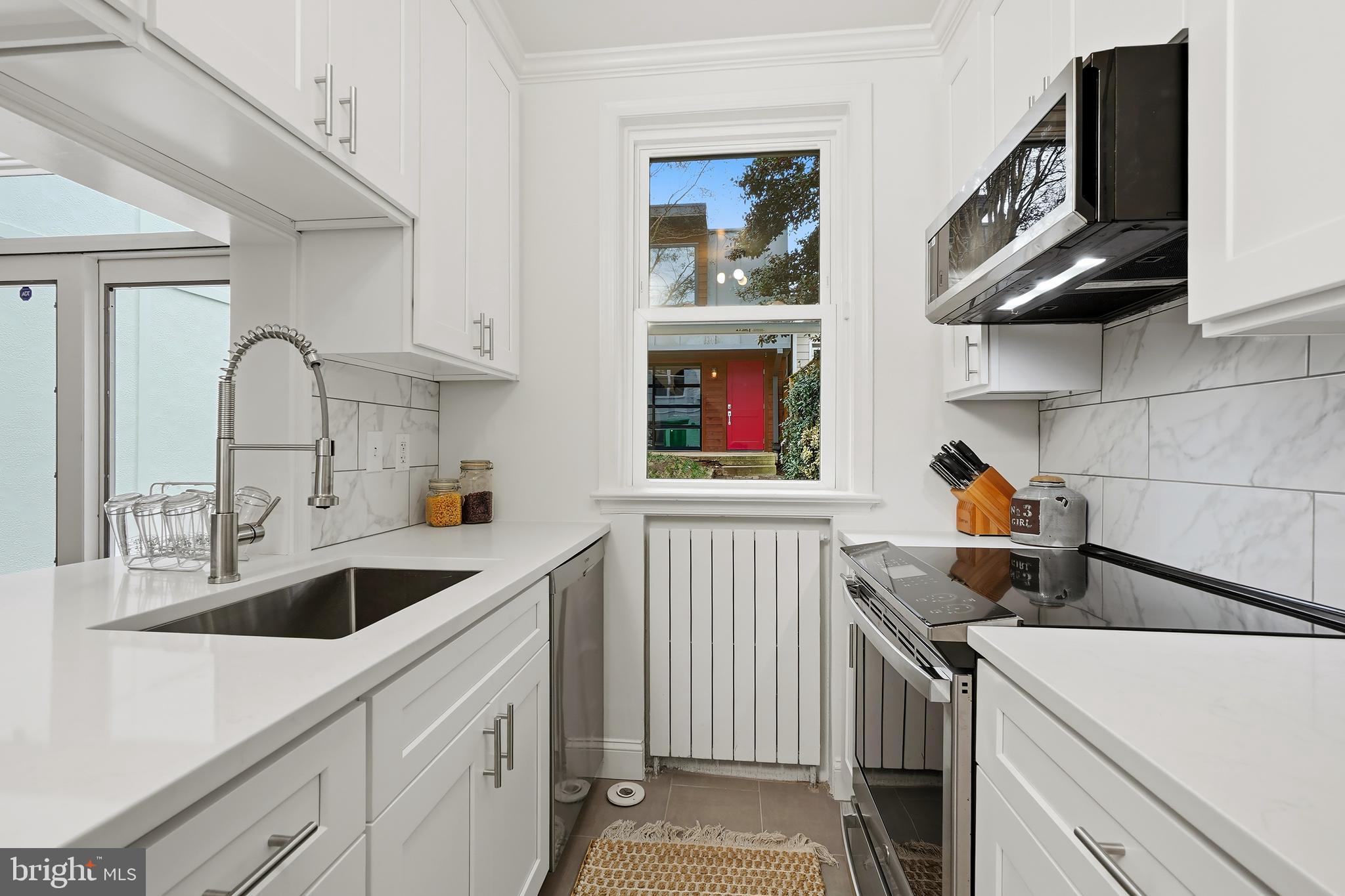 3520 S Street Northwest Washington, DC 20007 - Photo 10 of 44 a kitchen with a sink cabinets and a window