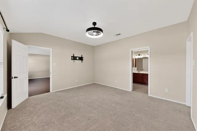 a view of an empty room with a ceiling fan