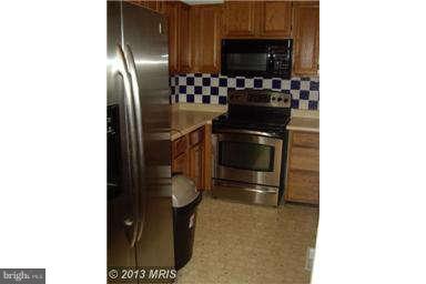 251 Delicious Road Linden, VA 22642 - Photo 11 of 27 a kitchen with stainless steel appliances a stove and a refrigerator
