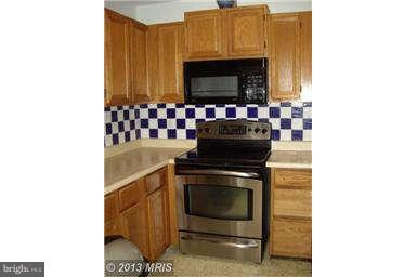 251 Delicious Road Linden, VA 22642 - Photo 12 of 27 a kitchen with a stove and a microwave