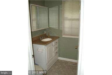 251 Delicious Road Linden, VA 22642 - Photo 15 of 27 a bathroom with a granite countertop sink and a mirror