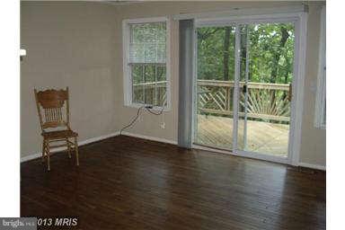 251 Delicious Road Linden, VA 22642 - Photo 4 of 27 a view of an empty room with wooden floor and a window