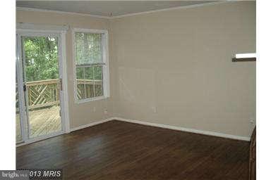 251 Delicious Road Linden, VA 22642 - Photo 5 of 27 an empty room with wooden floor and windows