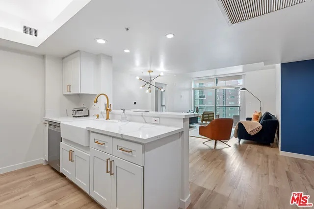 a kitchen with a sink cabinets and wooden floor