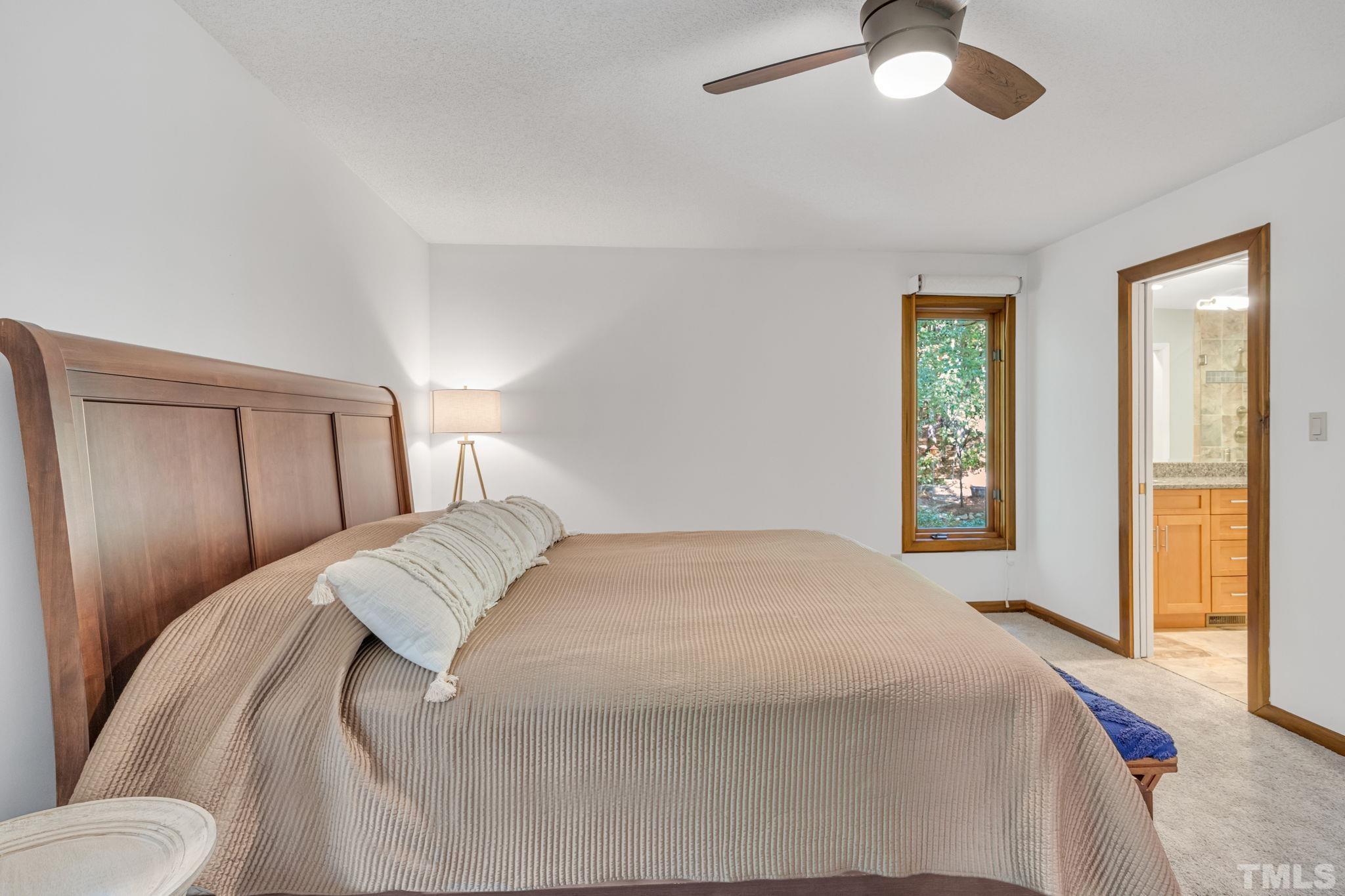 10229 Boxelder Drive Raleigh, NC 27613 - Photo 25 of 52 a bedroom with a bed and a chandelier