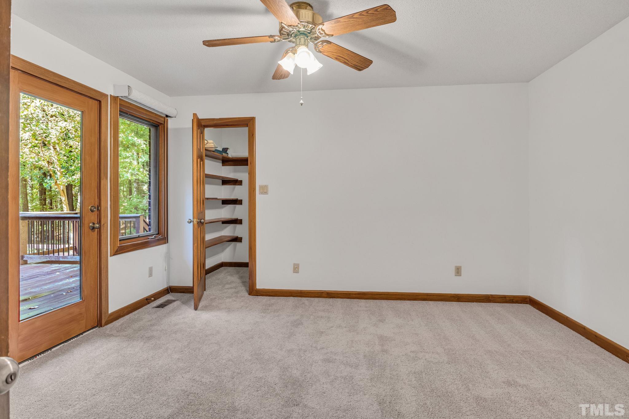 10229 Boxelder Drive Raleigh, NC 27613 - Photo 35 of 52 an empty room with windows and fan
