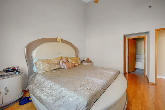 a large bed sitting in a bedroom next to a window