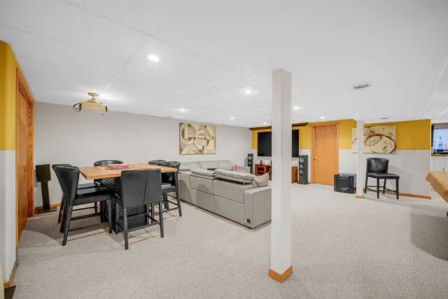 a living room with furniture a dining table and kitchen view