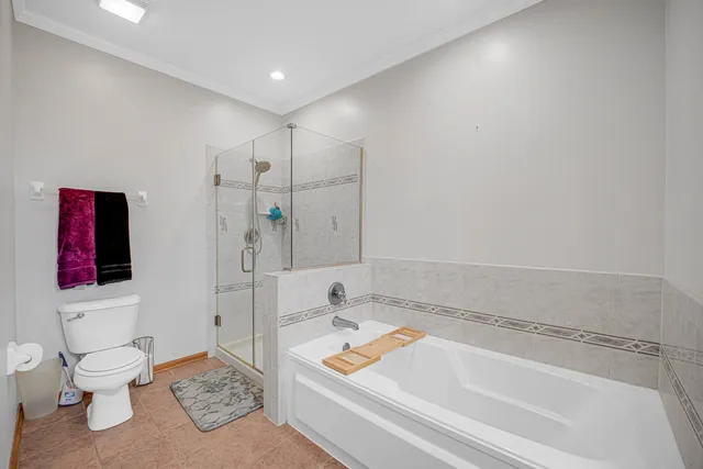 a bathroom with a tub and a toilet