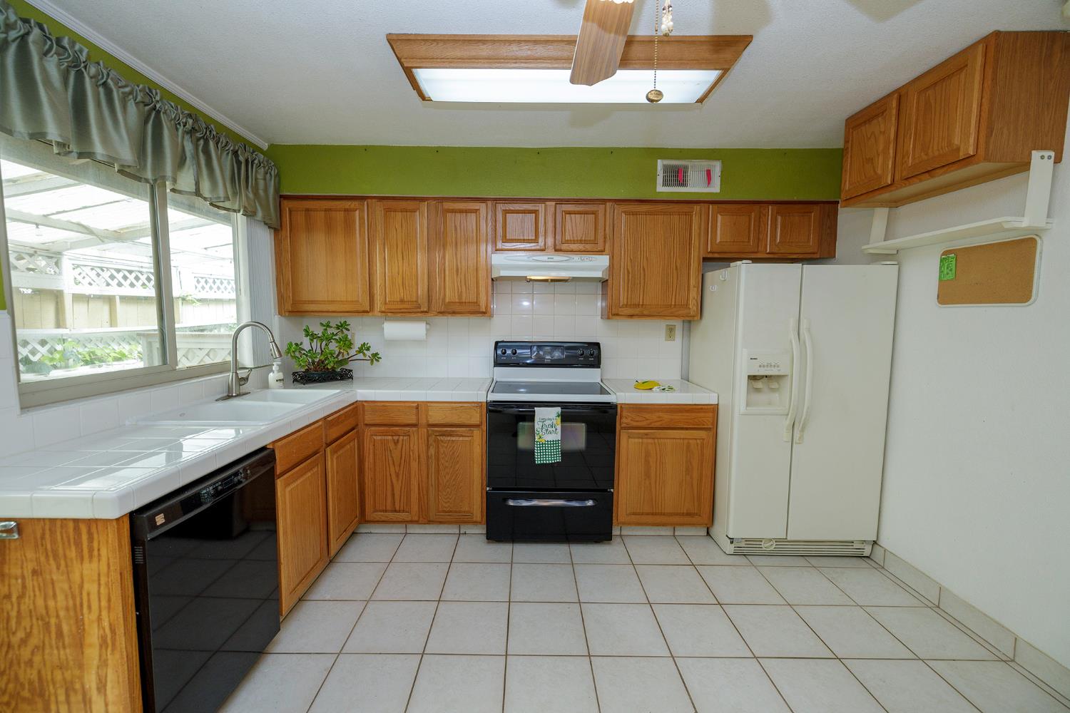 617 West Granger Avenue, Unit 48 Modesto, CA 95350 - Photo 11 of 27 a kitchen with stainless steel appliances granite countertop a stove a sink and a refrigerator