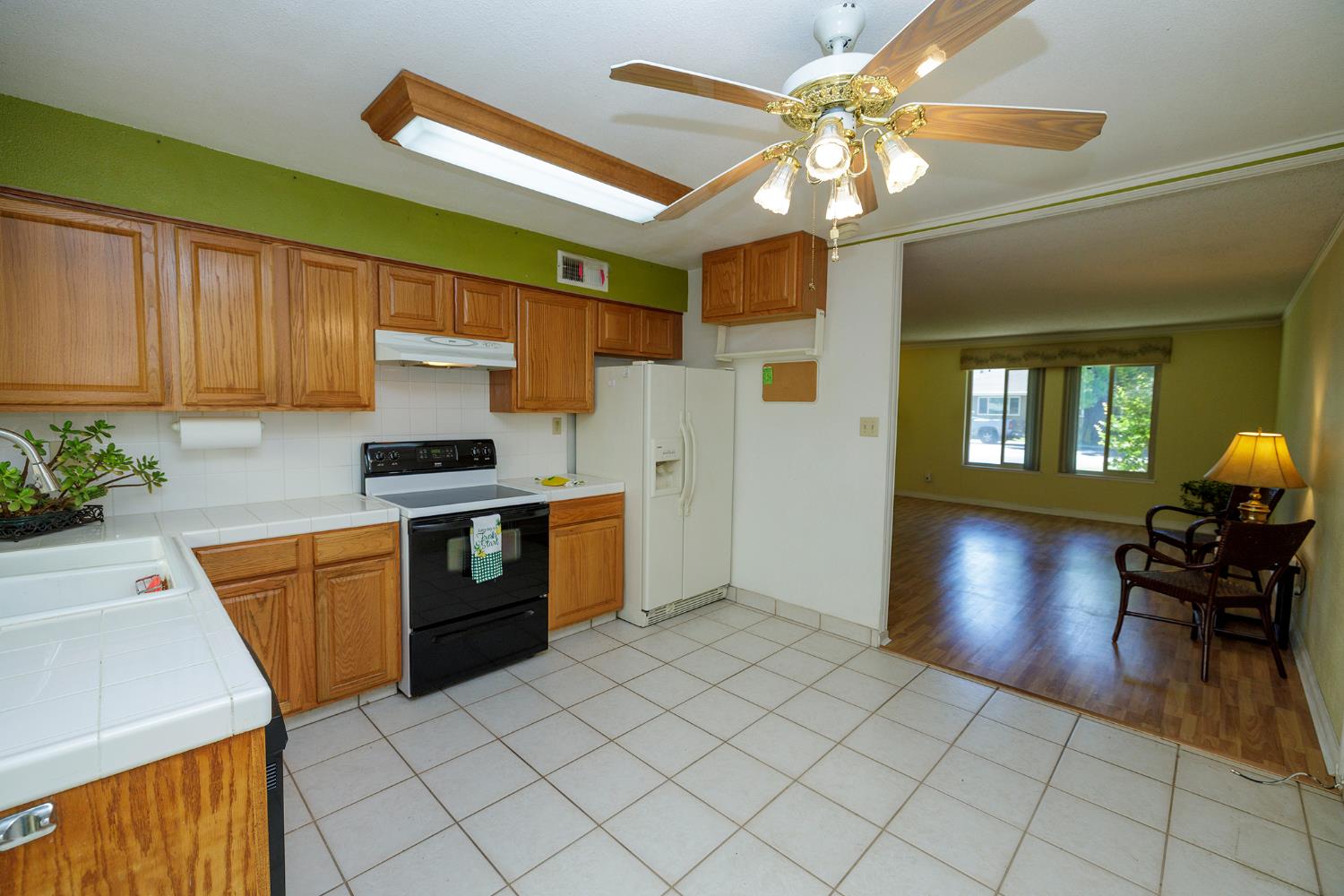 617 West Granger Avenue, Unit 48 Modesto, CA 95350 - Photo 12 of 27 a kitchen with stainless steel appliances granite countertop a sink dishwasher and a stove with wooden floor
