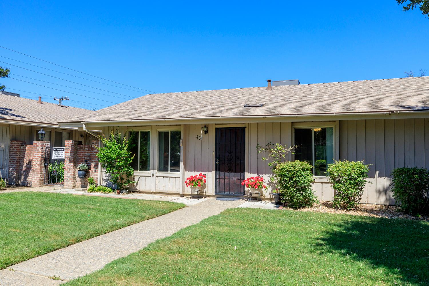 617 West Granger Avenue, Unit 48 Modesto, CA 95350 - Photo 2 of 27 a front view of the house with yard and green space
