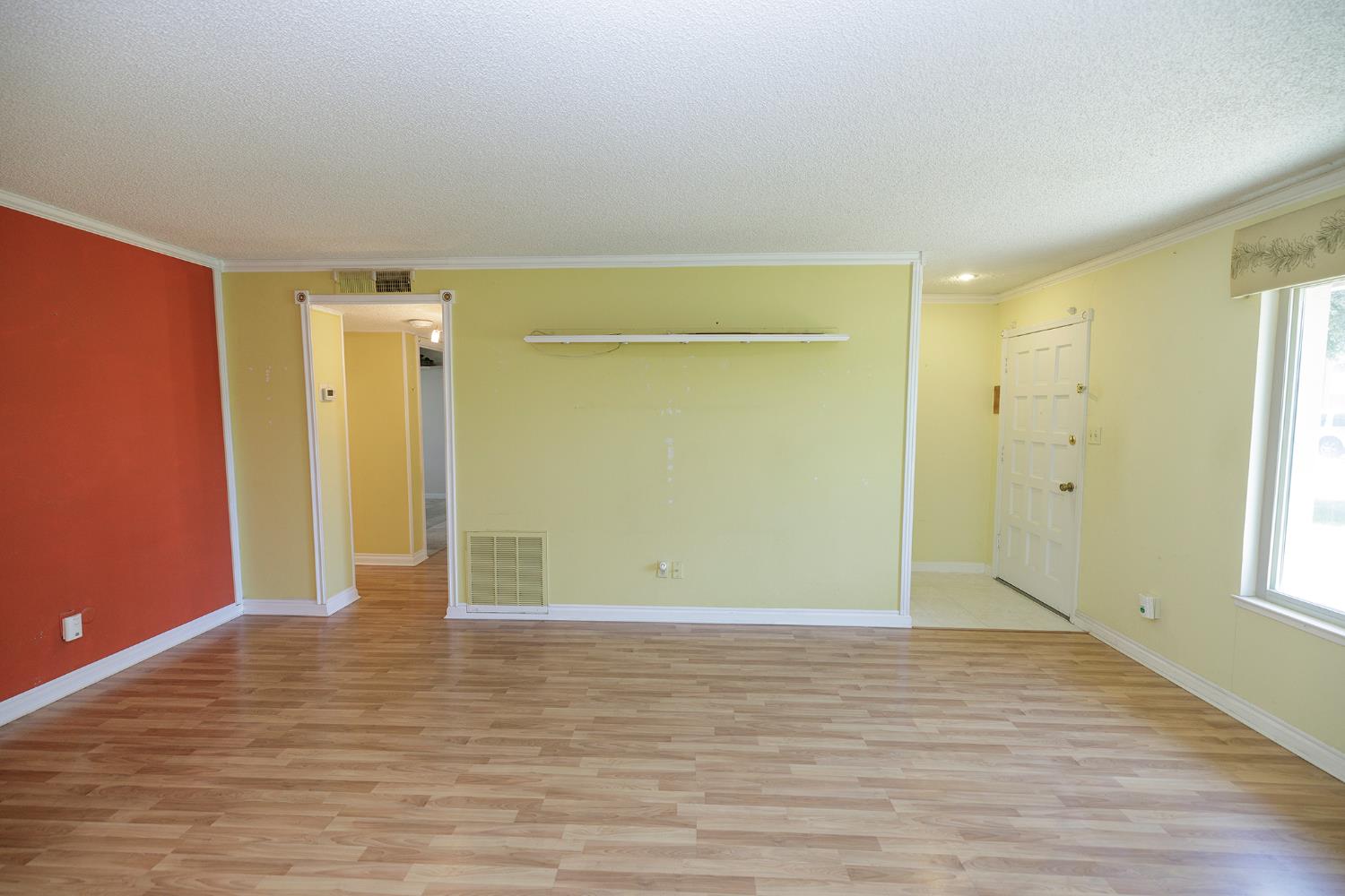 617 West Granger Avenue, Unit 48 Modesto, CA 95350 - Photo 7 of 27 a view of an empty room with wooden floor and a window