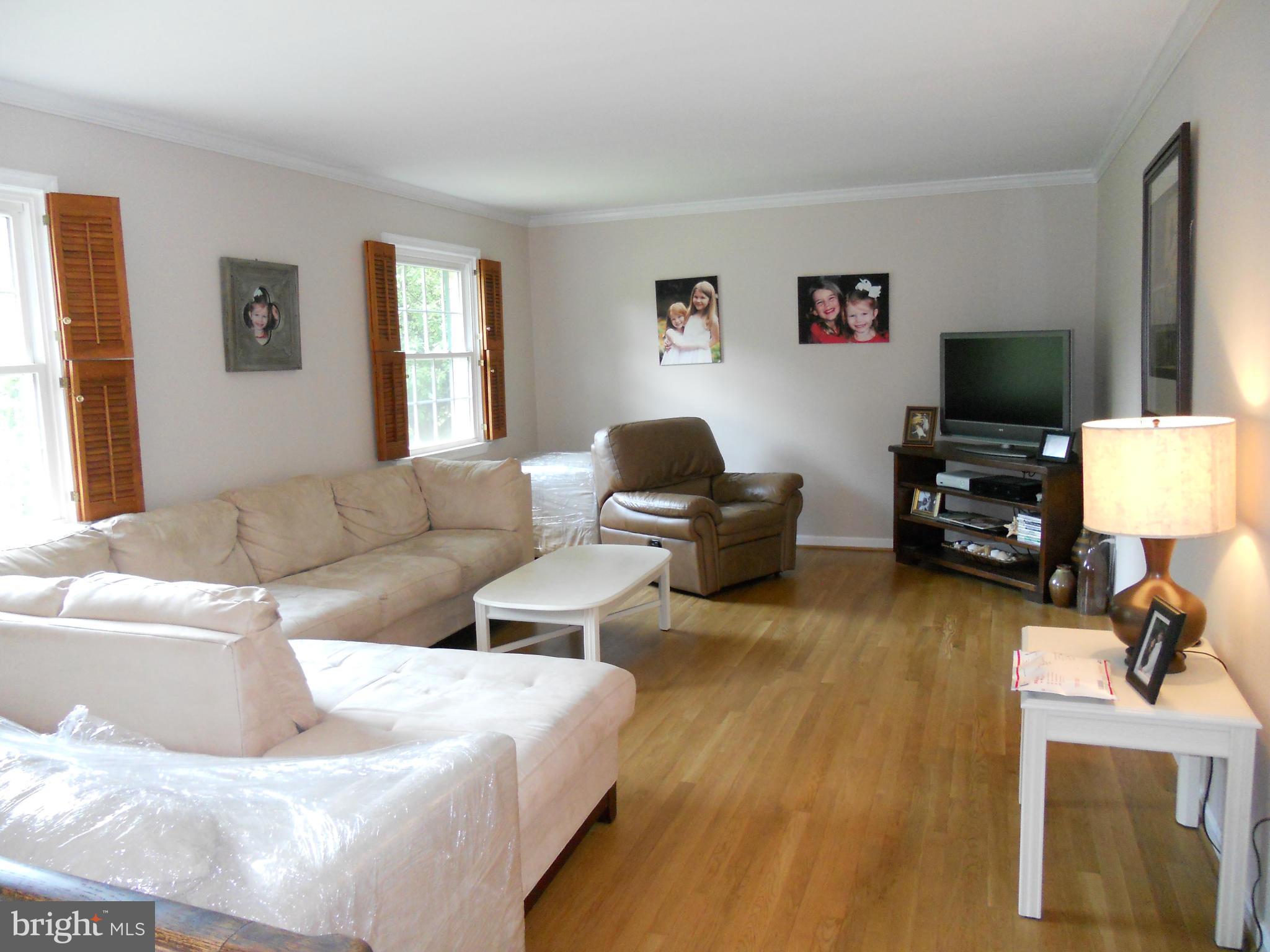 19129 Willow Grove Road Olney, MD 20832 - Photo 2 of 18 a living room with furniture window and a flat screen tv