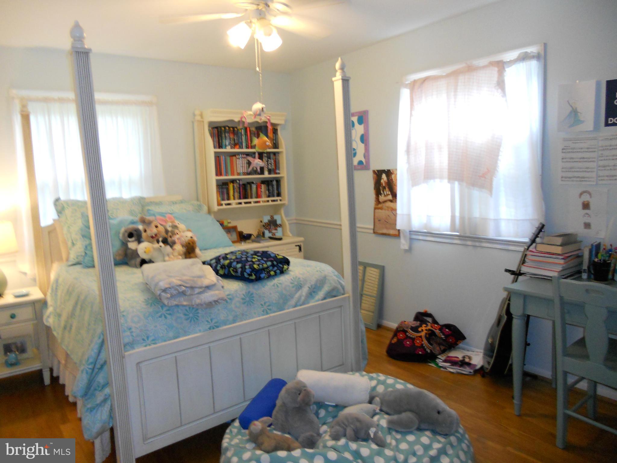 19129 Willow Grove Road Olney, MD 20832 - Photo 11 of 18 a bedroom with a bed and a dresser