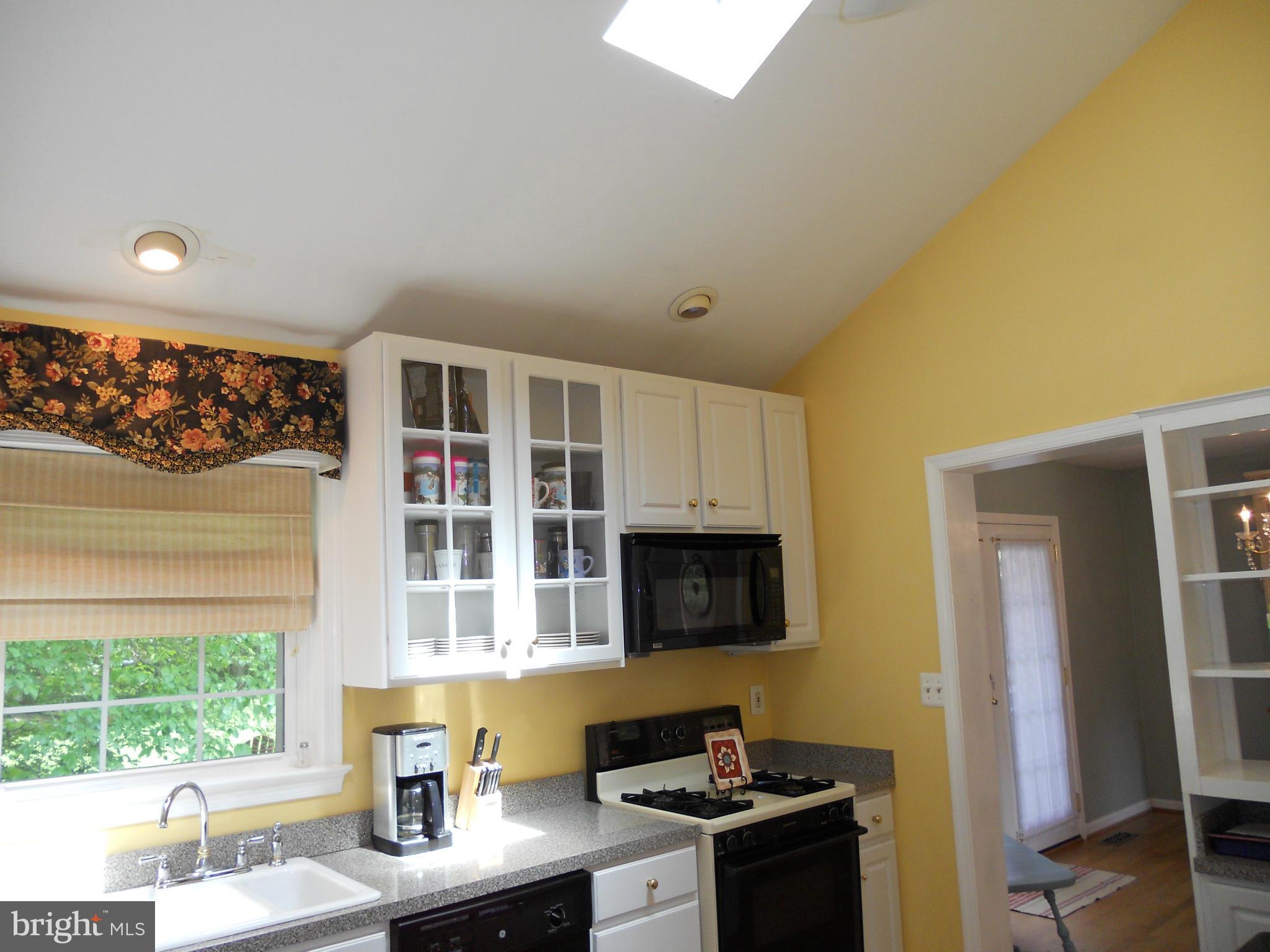 19129 Willow Grove Road Olney, MD 20832 - Photo 5 of 18 a kitchen with stainless steel appliances granite countertop a stove a sink and a microwave